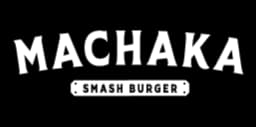 A bold, white, distressed-style logo for 'MACHAKA' prominently displayed against a solid black background, with the tagline 'SMASH BURGER' in smaller, pixelated font centered beneath it inside a rectangular outline, suggesting a modern, edgy branding identity for a burger establishment.